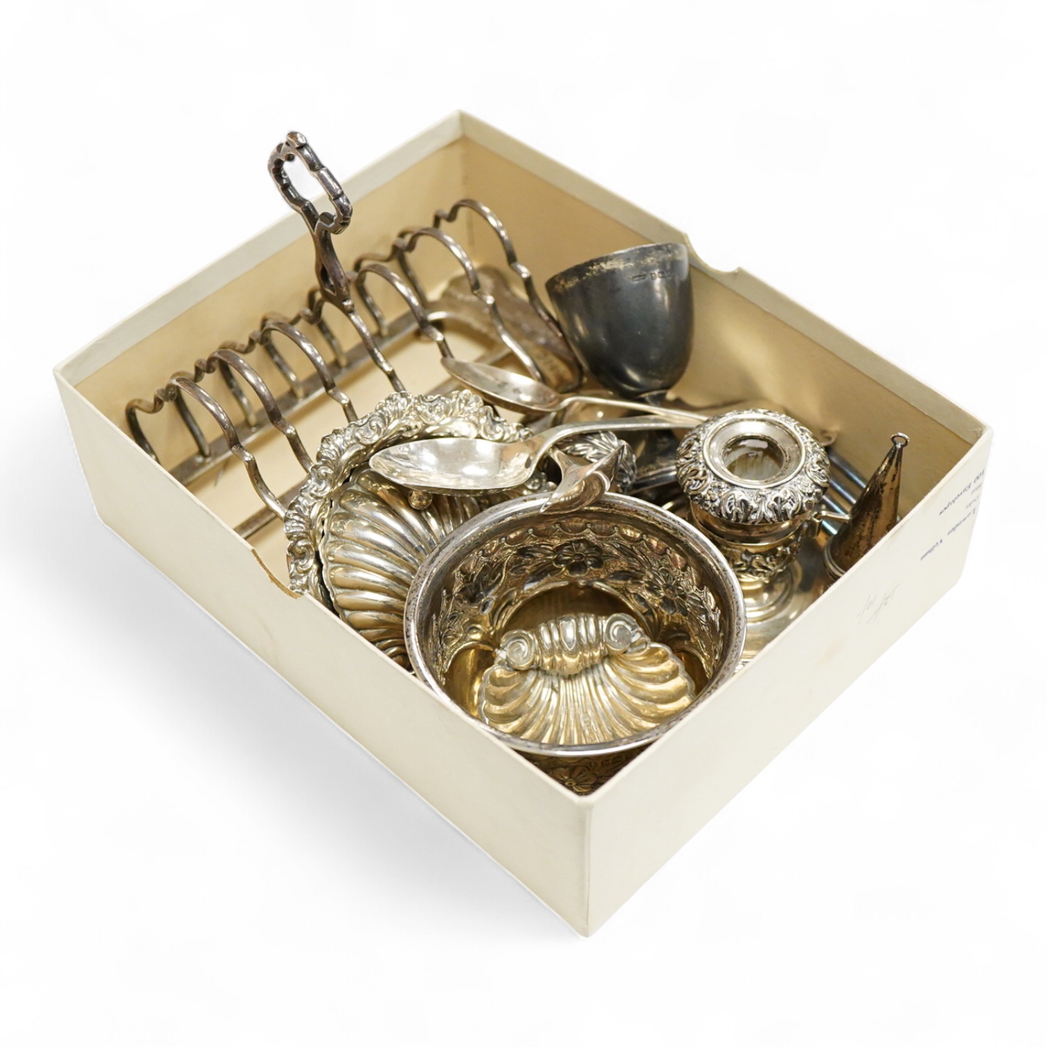 A collection of small silver, to include a late Victorian seven bar toast rack, by Edward Gilbert, London, 1887, length 13.3cm, a late Victorian bowl, pair of shell salts, nut dish, egg cup, Georgian chamberstick(part of